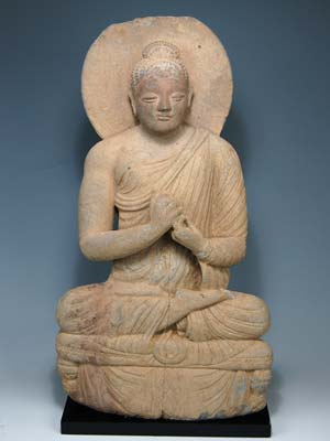 A large gray schist figure of a seated Buddha, Gandhara c. 3rd century A.D.