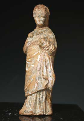 A charming Greek terracotta of a young girl, ca 3rd century BC