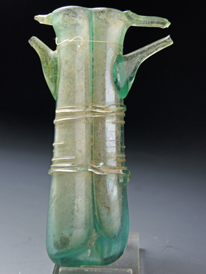 A Roman Green Glass Double Balsamarium with Applied Handles, c. 4th century A.D.