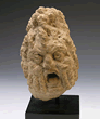 An Egyptian limestone theatre head of a man, Roman Period ca 1st century AD